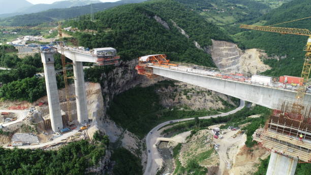 istock Aerial drone view on highway bridge road under construction. Construction of the viaduct on the modern new road. 1450575392