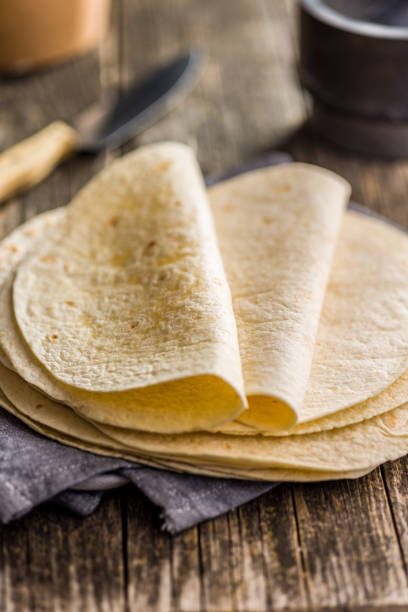 istock Mexican Corn Tortillas on wooden table. 1450575903