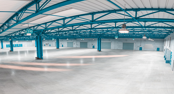 interior of an empty modern warehouse with blue structures. fisheye. 3d render