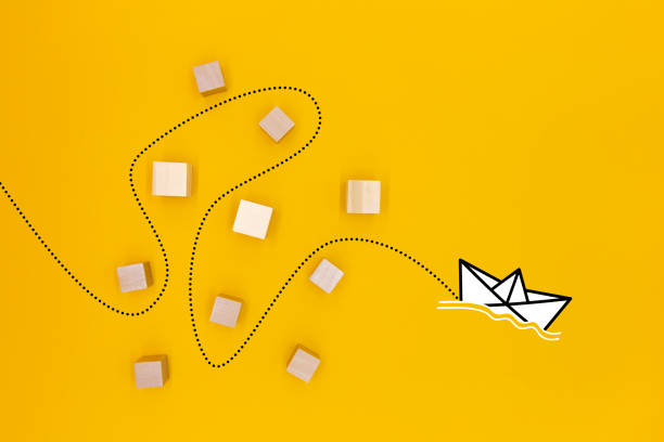 istock a paper boat that passes through obstacles and advances to its goal 1450578122