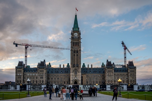 Ottawa, Canada – October 18, 2022: Ottawa, Ontario - October 18, 2022: The Centre Block of  Canada's Parliament Hill  during the evening.