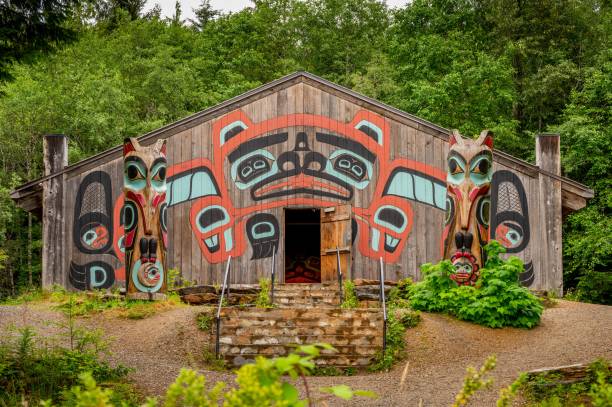 Tlingit totem poles, long house and traditional art in Saxman, Alaska Saxman, United States – July 29, 2022: Saxman, Alaska - July 29, 2022: Tlingit totem poles, long house and traditional art. southeastern alaska stock pictures, royalty-free photos & images