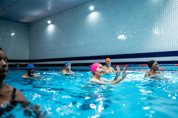 istock Senior people exercising in the swimming pool 1450583204