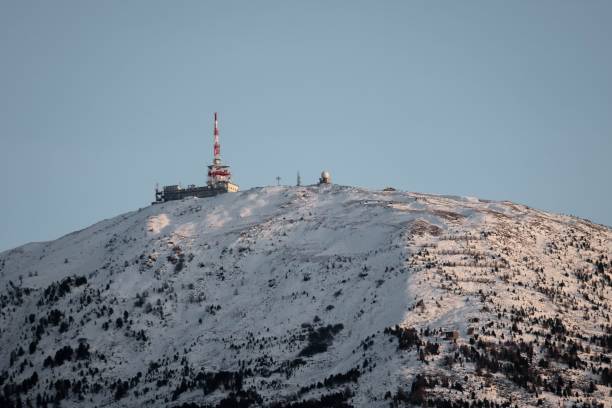 istock View of a snowy mountain peak with a transmitter tower. 1450583272
