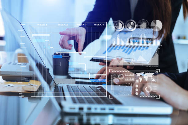 istock Businessman hand Project manager working and update tasks and Gantt chart scheduling virtual diagram.with smart phone, tablet and laptop in office. 1450583851