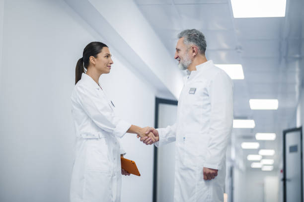 istock Two doctors shaking hands during appointment in the clinic 1450585060