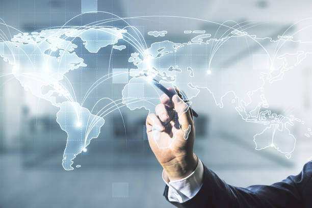 istock Man hand with pen working with abstract graphic digital world map with connections on blurred office background, globalization concept. Multiexposure 1450585738