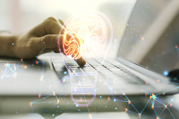 istock Creative light bulb illustration with human brain and with hands typing on computer keyboard on background, future technology concept. Multiexposure 1450585878