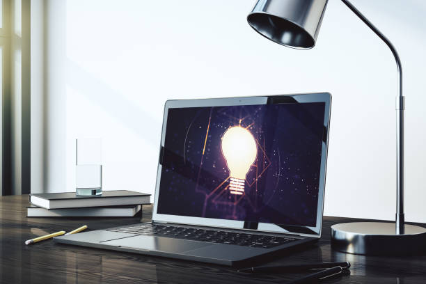 istock Modern computer monitor with creative light bulb hologram, research and development concept. 3D Rendering 1450586103