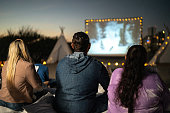 Group of people watching a movie at the outdoors cinema