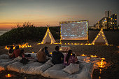 Group of people watching a movie at the outdoors cinema
