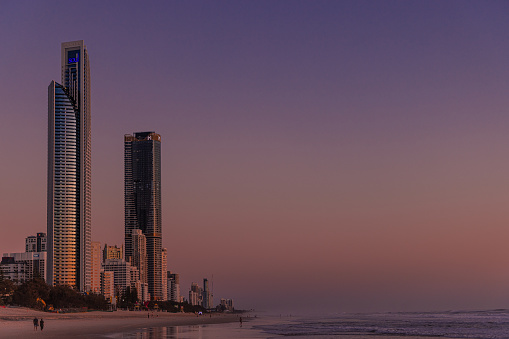 Gold Coast, Queensland, Australia - October 28, 2022: The vibrant colours of sunrise over Surfers Paradise Beach on the Gold Coast.
