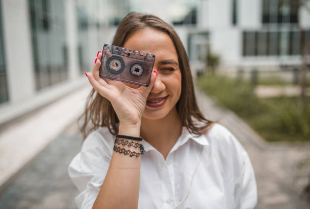 istock Woman holds an audio cassette 1450588894