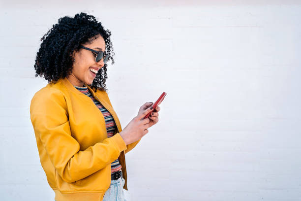 istock Curly Haired Woman Using Phone 1450589305