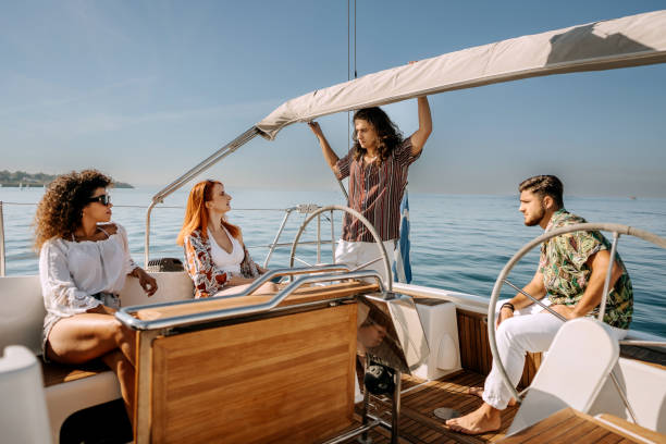 istock Friends having fun while riding on a yacht together 1450589800