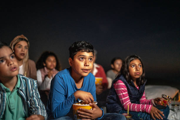 group of people watching a movie outdoors - audience surprise movie theater shock imagens e fotografias de stock