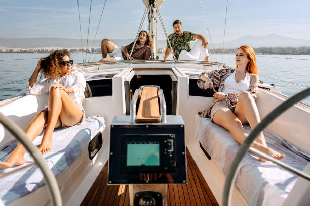 istock Friends having fun while riding on a yacht together 1450589853