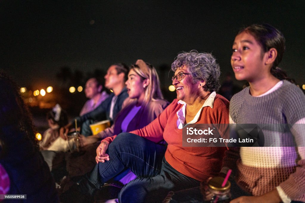 Group of people enjoying a movie at the outdoors cinema Movie Theater Stock Photo