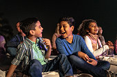 Children talking and laughing at the outdoors cinema