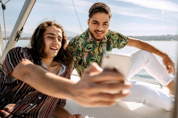 istock Two young male friends taking a selfie while yachting together 1450590078