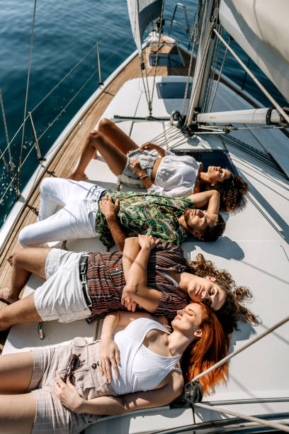 istock Group of friends taking a nap while riding on a yacht 1450591231