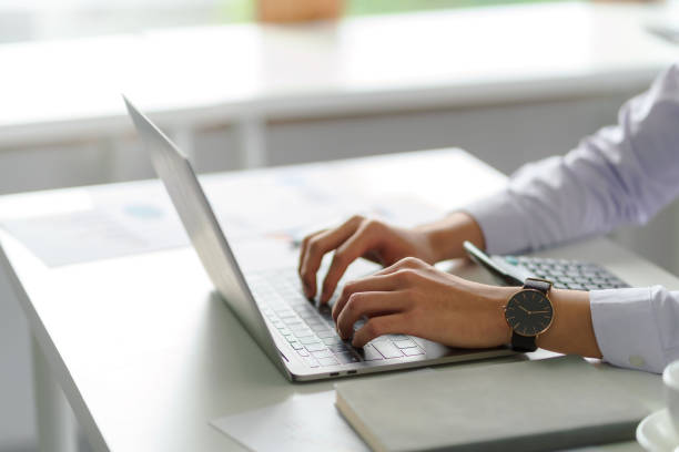 istock female hand typing computer on desk in office. 1450592099