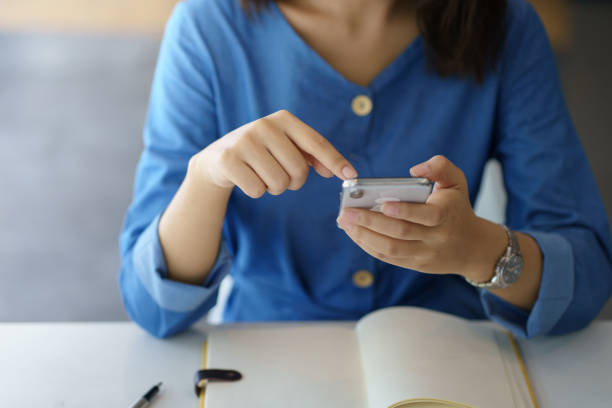 istock Woman using mobile phone to send text , work or play social media. 1450592115