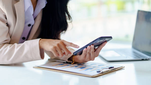 istock Woman using mobile phone to send text , work or play social media. 1450592123