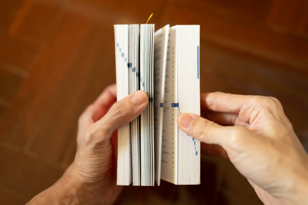 istock A man using dictionary to find a definition of words 1450593088
