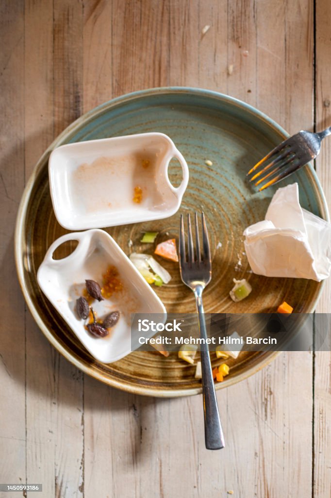 Left overs of a breakfast on table Dirty dishes on wooden table Above Stock Photo