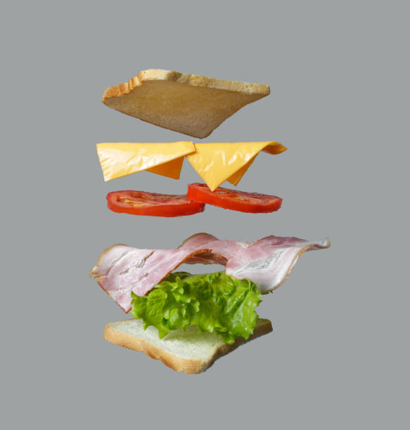 istock flying sandwich. Bread with ham, tomato, onion and salad. isolated on gray 1450594151