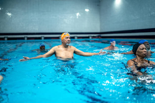 istock Senior man exercising in the swimming pool 1450594740