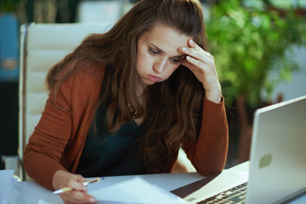 istock business owner woman in green office working with documents 1450595124