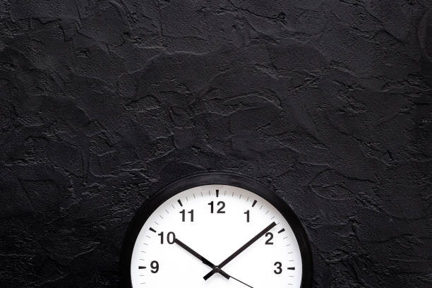 istock Round wall black and white clock. Time to work or rest concept 1450595621