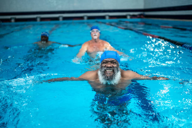 istock Senior man exercising in the swimming pool 1450596979