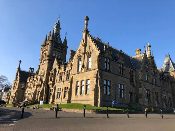 A beautiful shot of the Morgan Academy under the clear sky in Dundee, Scotland