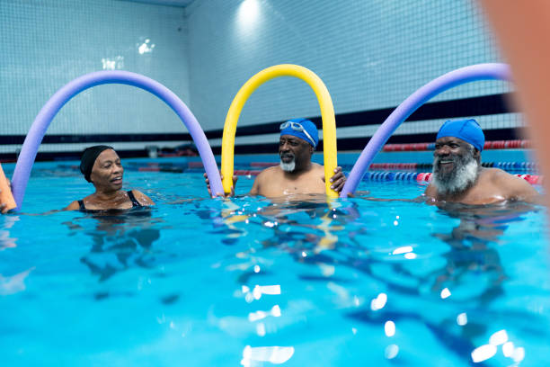 istock Senior people exercising in the swimming pool 1450598477