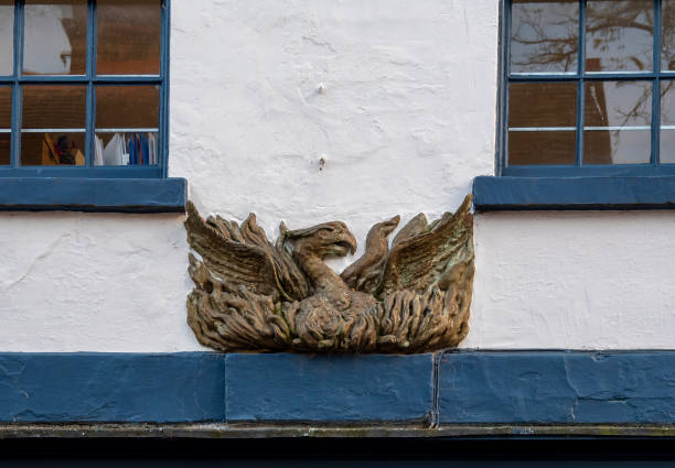 A bas relief of a phoenix above a doorway on an old building in Thoroughfare in Woodbridge, Suffolk, Eastern England. Possibly an antique fire insurance mark.