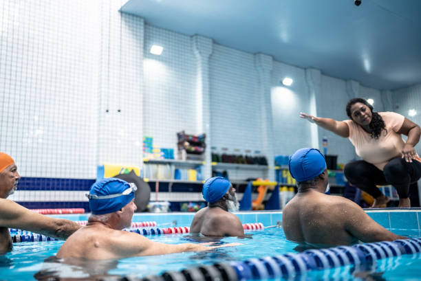 istock Senior men learning to swim in the swimming pool 1450599516