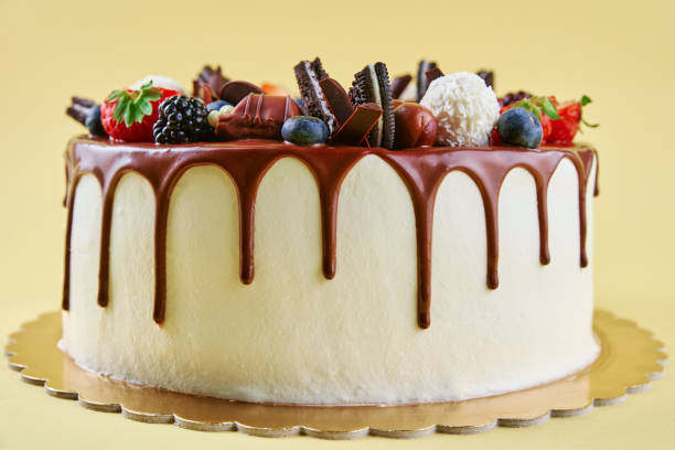 istock Cake decorated with strawberry and chocolate on yellow background 1450600468