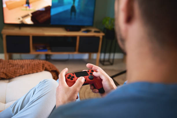 istock Boy and man playing video game at home 1450601187