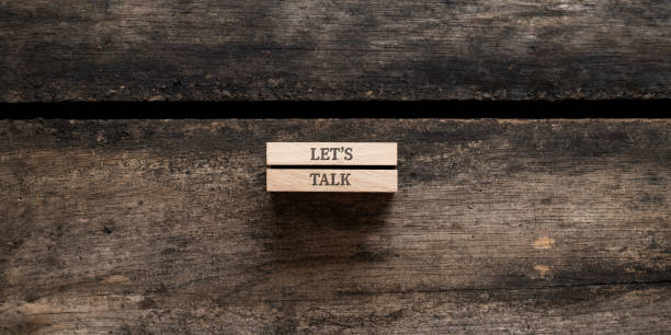istock Lets talk sign written on two wooden pegs 1450607326