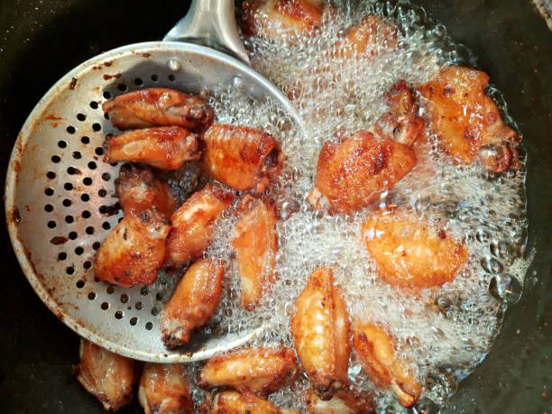 istock Cooking Fried Chicken wing - food preparation. 1450610154