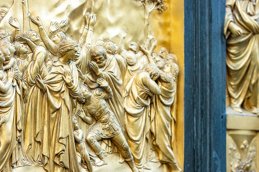 East Doors (Gates of Paradise) by Lorenzo Ghiberti on Florence Baptistery (Battistero di San Giovanni) in Tuscany, Italy. These doors consist of 10 panels depicting scenes from the Old Testament and were commissioned in 1424. Once completed, they were described by Michelangelo as being fit to be the 'gates of paradise'. The doors displayed are now a copy of the original, with those being displayed in a local museum.