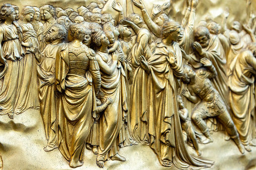 East Doors (Gates of Paradise) by Lorenzo Ghiberti on Florence Baptistery (Battistero di San Giovanni) in Tuscany, Italy. These doors consist of 10 panels depicting scenes from the Old Testament and were commissioned in 1424. Once completed, they were described by Michelangelo as being fit to be the 'gates of paradise'. The doors displayed are now a copy of the original, with those being displayed in a local museum.