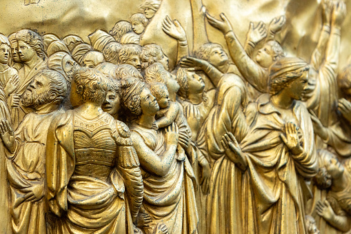 East Doors (Gates of Paradise) by Lorenzo Ghiberti on Florence Baptistery (Battistero di San Giovanni) in Tuscany, Italy. These doors consist of 10 panels depicting scenes from the Old Testament and were commissioned in 1424. Once completed, they were described by Michelangelo as being fit to be the 'gates of paradise'. The doors displayed are now a copy of the original, with those being displayed in a local museum.