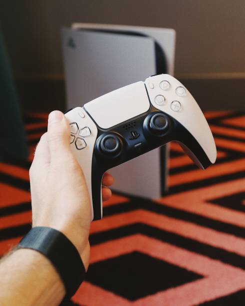 Playstation 5 The new Sony Playstation 5 gaming console with the DualSense controller 4k gaming stock pictures, royalty-free photos & images