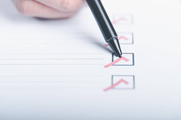 istock human hand check mark on paper,check concept through checkboxes, surveys through questionnaires, comments to lead Develop and fix bugs,Marking On Checklist 1450624574