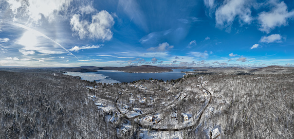 Panoramic Aerial View of Lac St-Joseph in Winter Season, Quebec, Canada. This lake is located 30 minutes away from Quebec City in town of Fossambault-Sur-Le-Lac. The ice begin to be visible on the lake as the winter is coming.