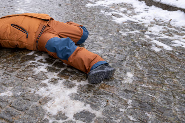 Child is lying on a icy way stock photo